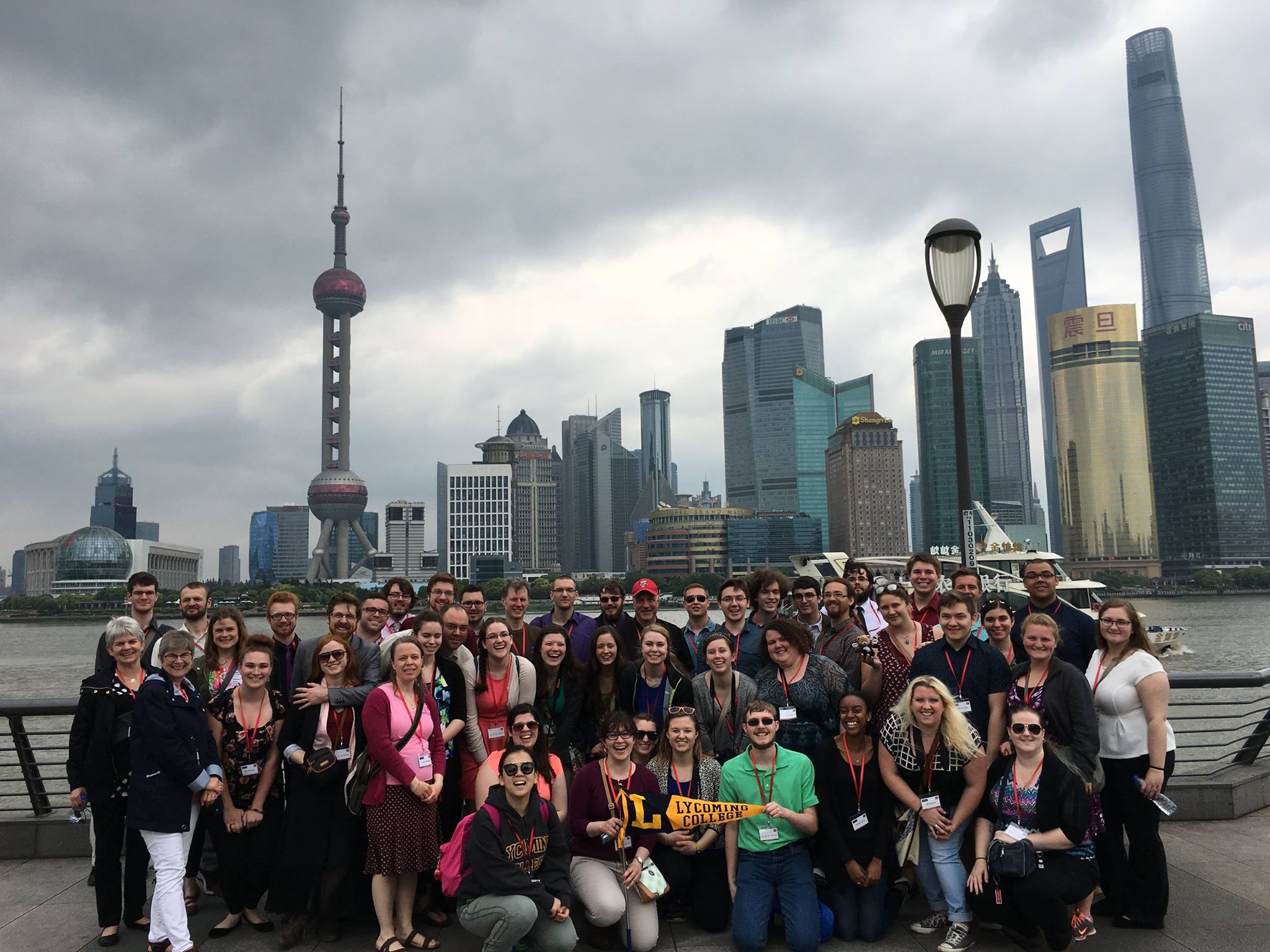 Posing for a group photo in Shanghai. Behind them are the Huangpu River and the Pudong financial district.