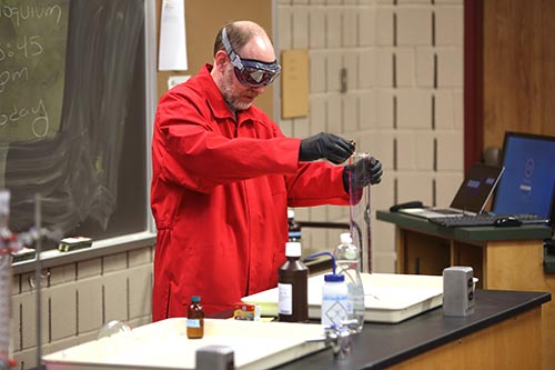 Dr. Jeremy Ramsey performing a chemical demonstration