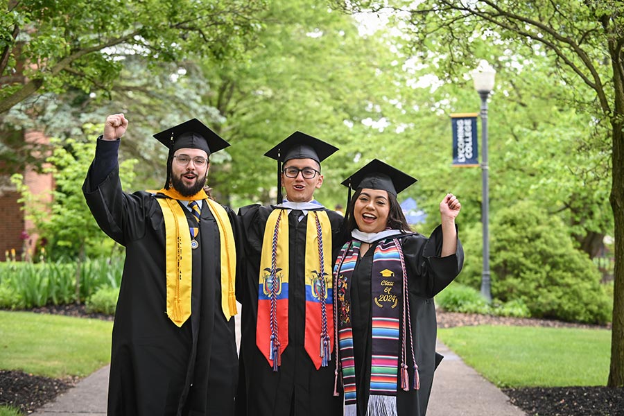 Graduates celebrating outside on campus