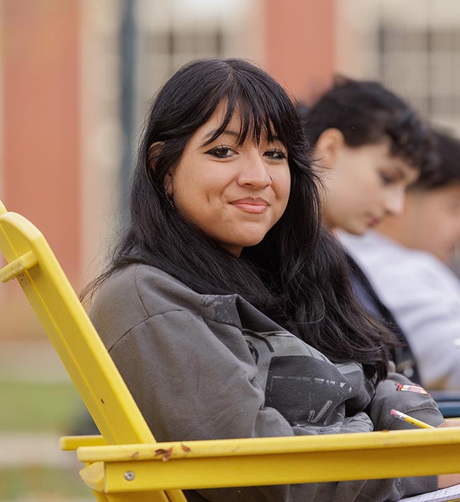 Students sitting on chairs outdoors