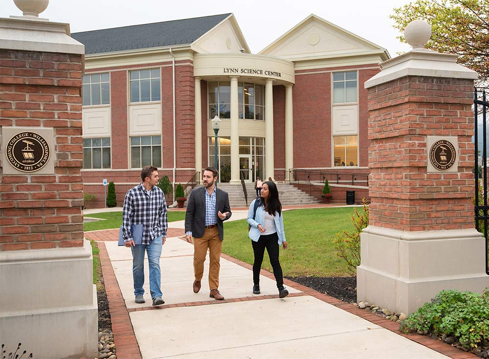 Students walking with a professor in front of the Lynn Science Center