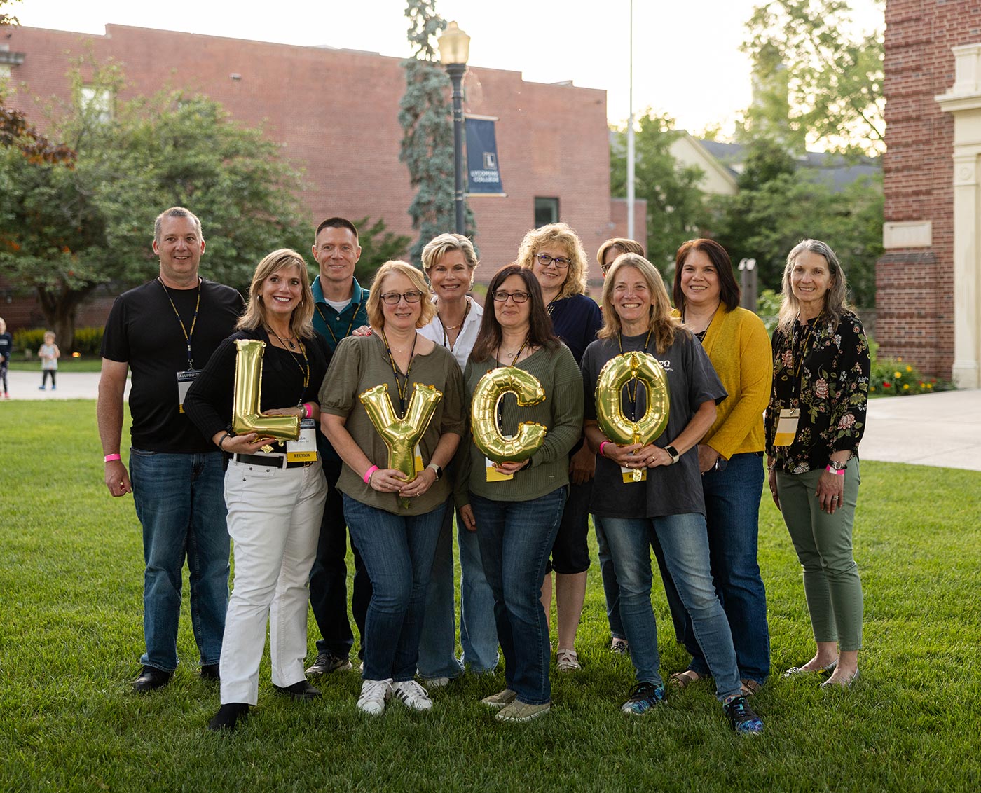 Alumni with balloons spelling out LYCO