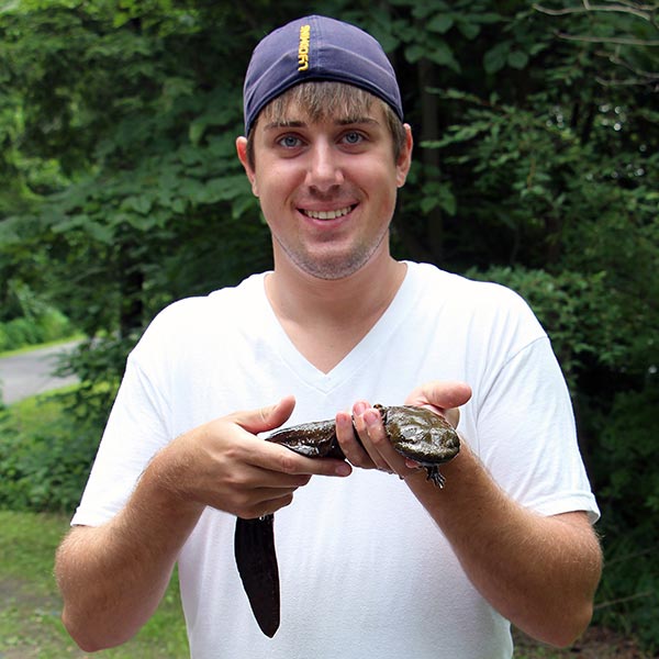 Student holding a hellbender