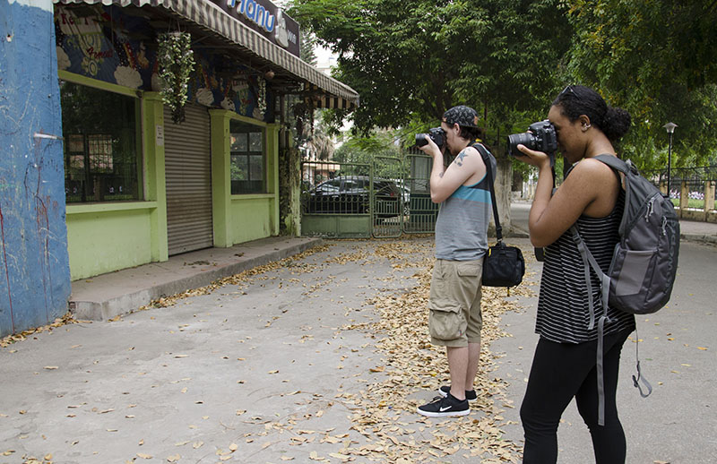 Students Jake Merkel and Jetta Harrison photograph at Hanoi University before meeting their Vietnamese student partners for the day.